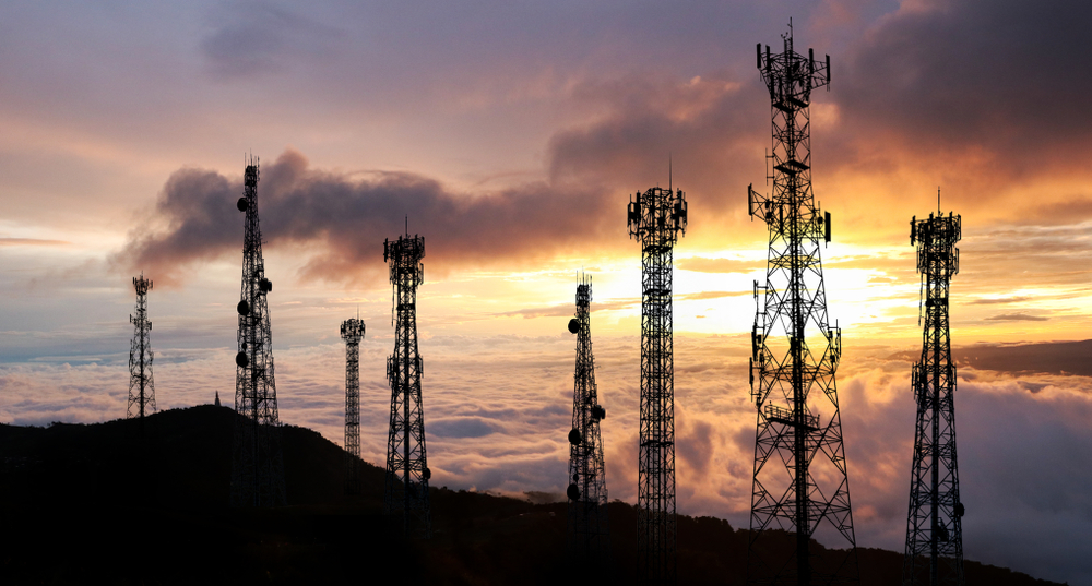 Antenna Telephone and communication towers have a sunset background.